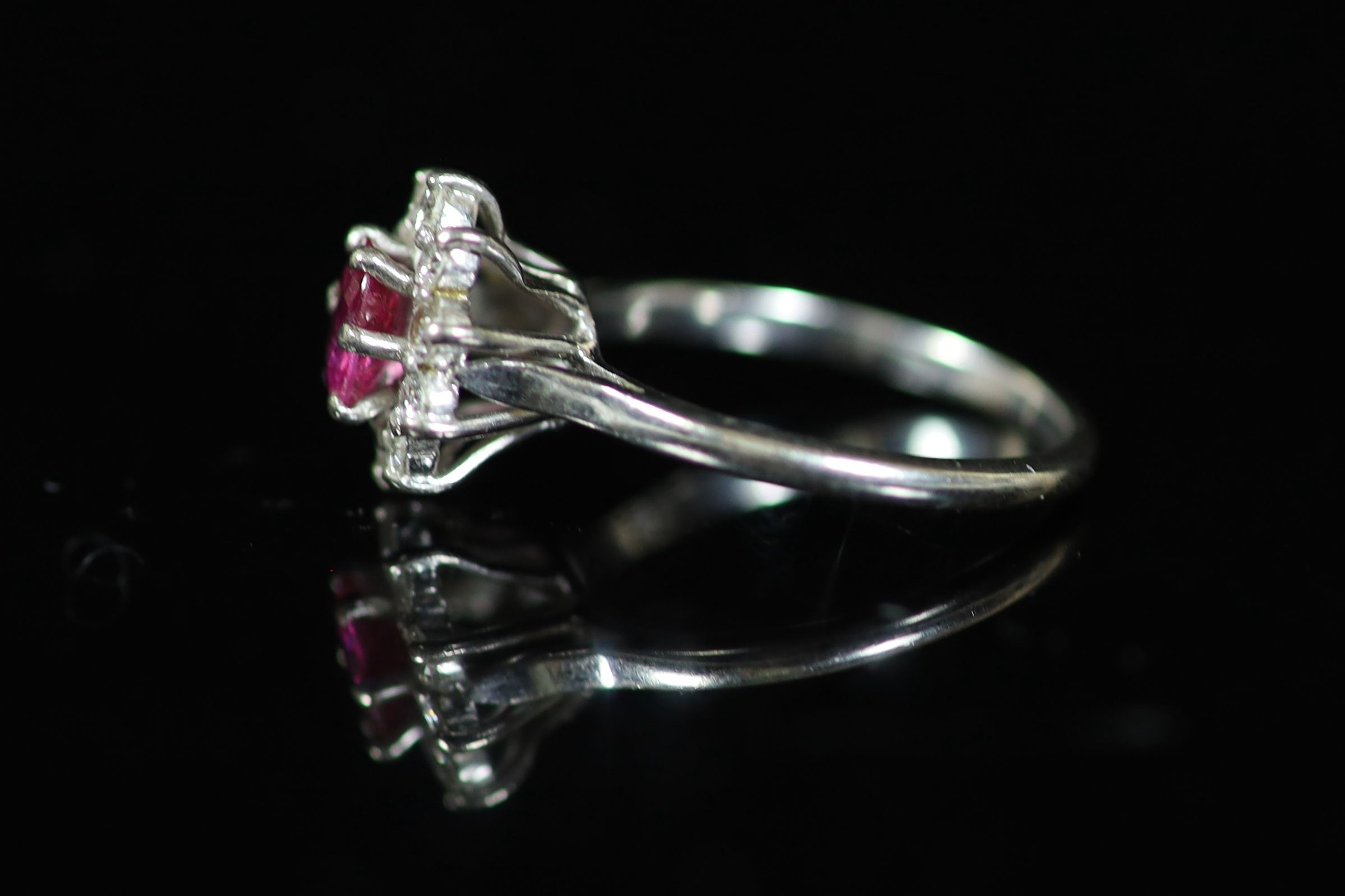 A white gold, ruby and diamond set flower head cluster ring